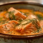 Bowl of creamy salmon soup garnished with dill